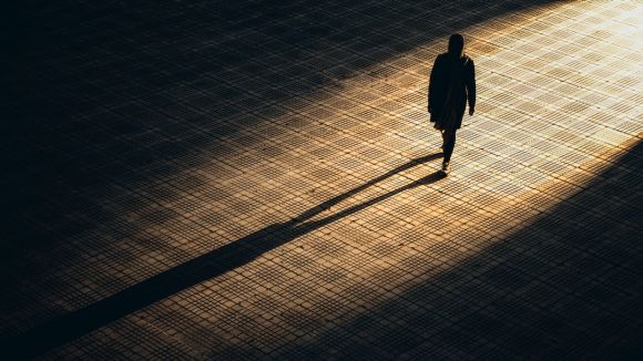 Human Mind - man in black jacket walking on brown brick floor