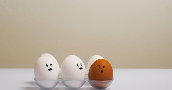 Psychology, Prejudice, Discrimination - Eggs in Tray on White Surface